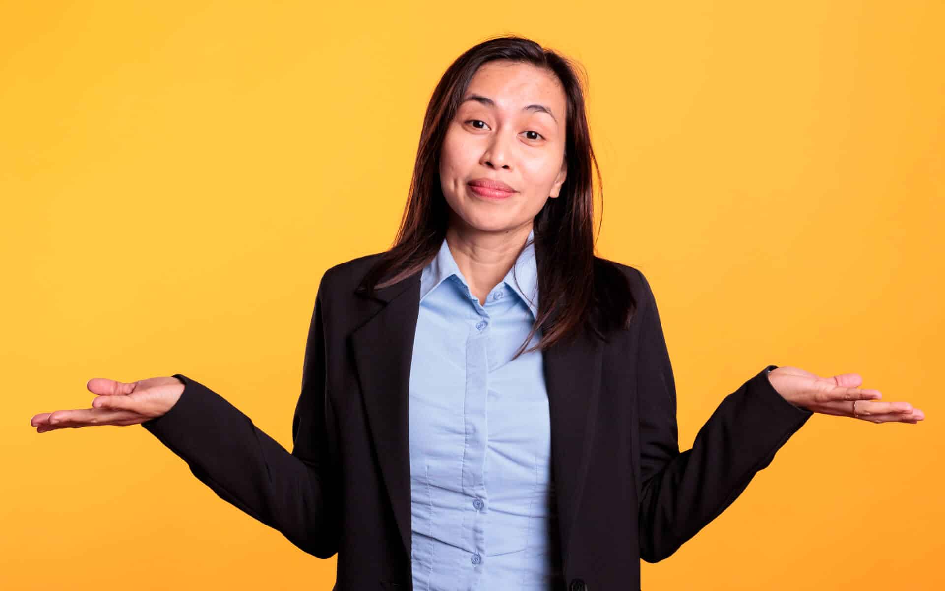A Filipino woman shrugs "I don't know" mannerism